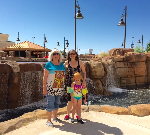 Linda with a woman and a young girl beside a waterfall.