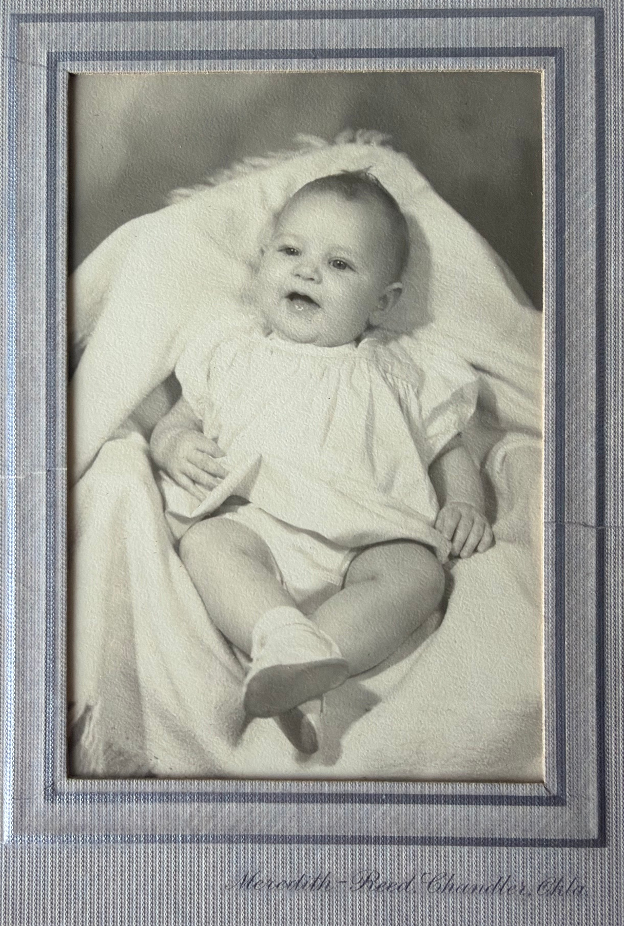 Linda as a smiling baby, with the original studio mount and lettering.